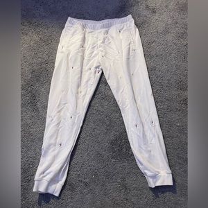 White joggers with different colored lightening bolts